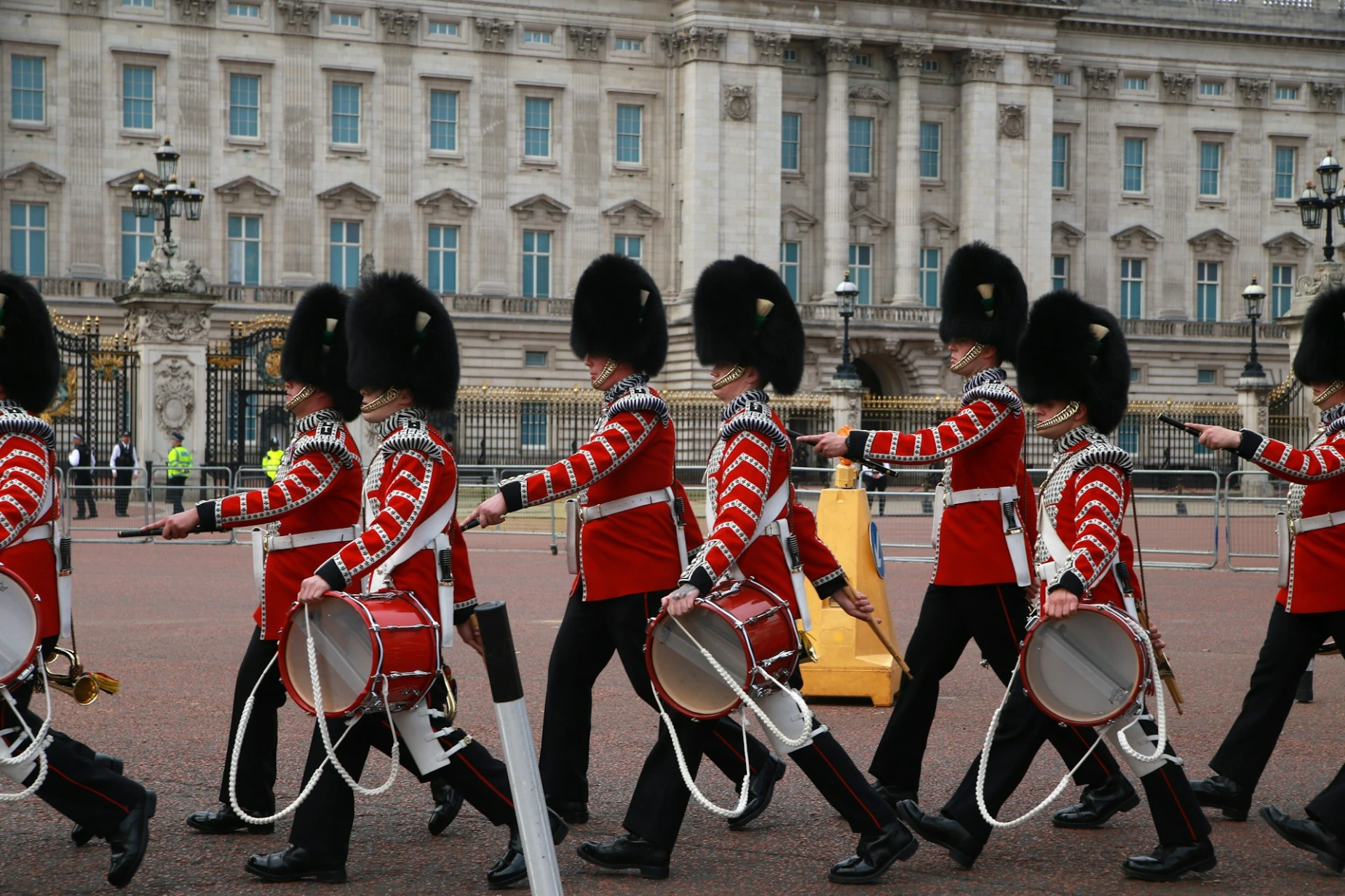 a group of men in uniform marching down a street