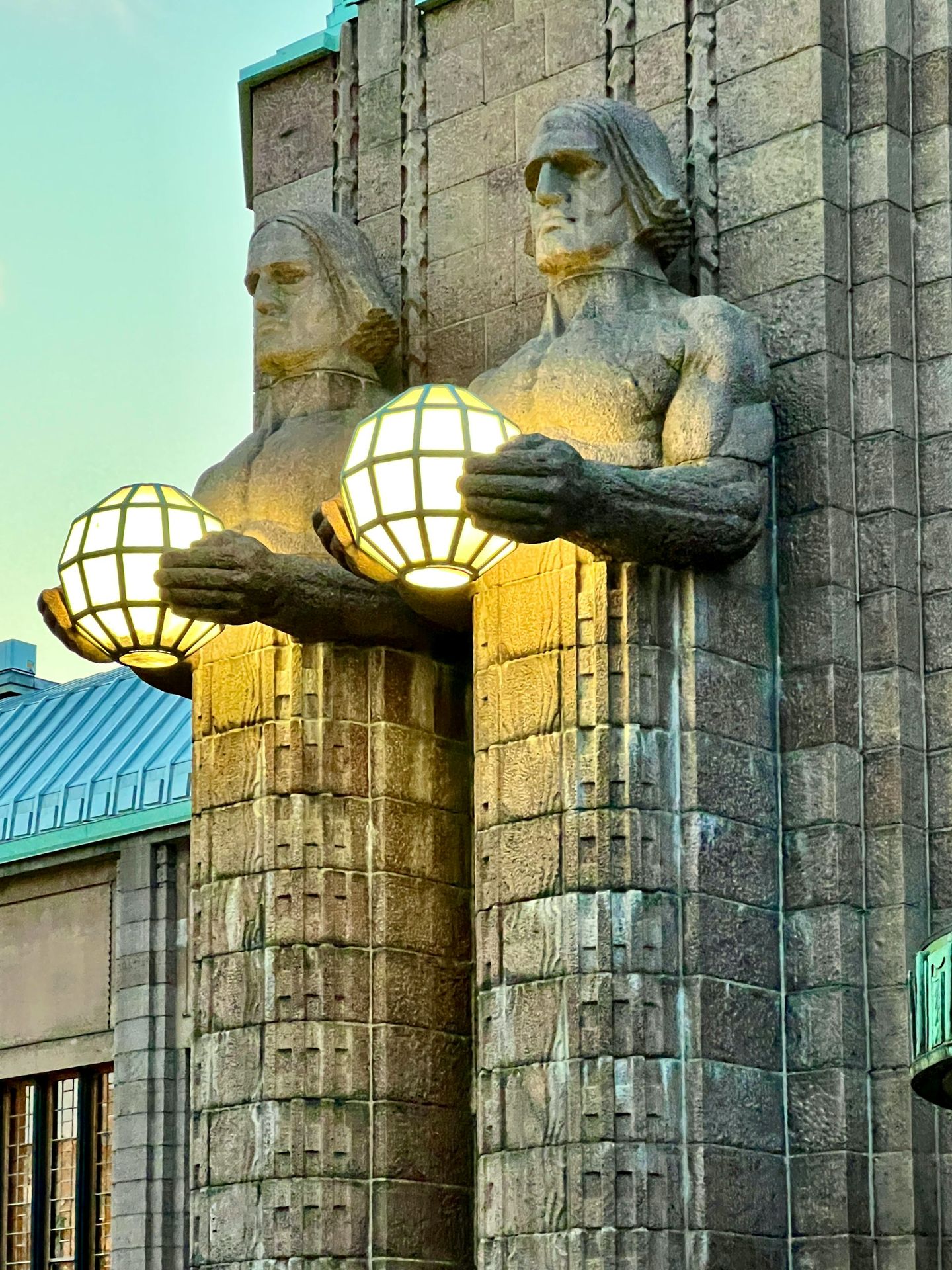 a statue of a person holding a light bulb