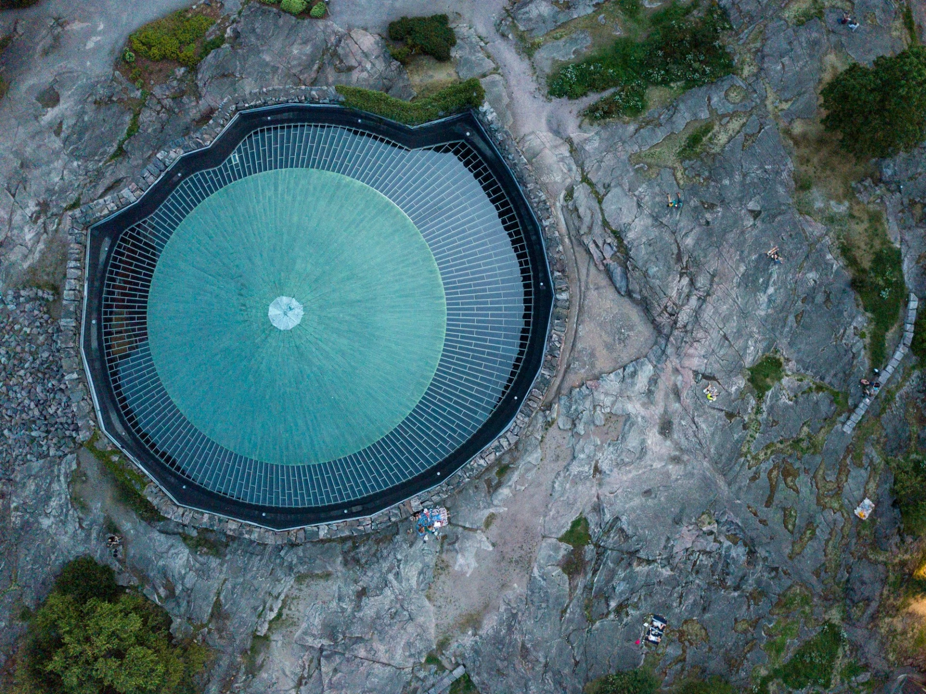 an aerial view of a building with a circular roof